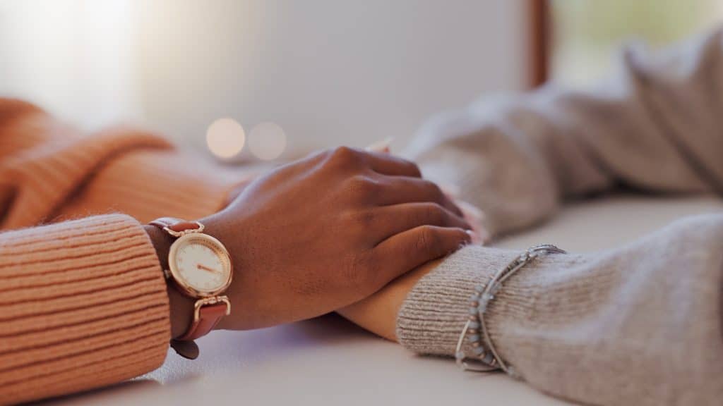 friend holding hands showing support