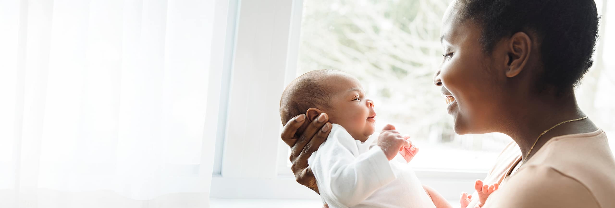 Portrait of a beautiful mother, holding her nursing baby