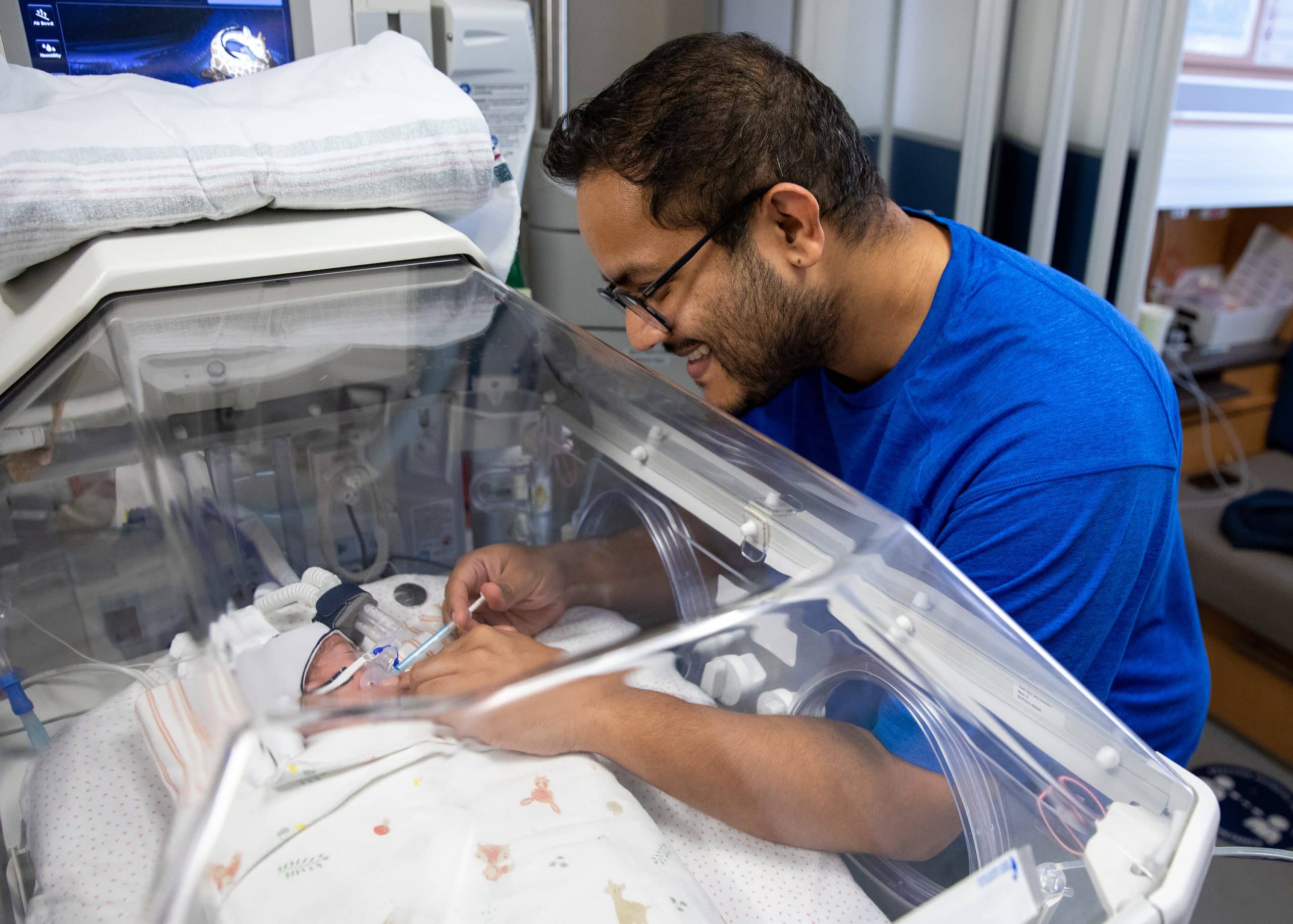 dad feeding baby in nicu donor milk