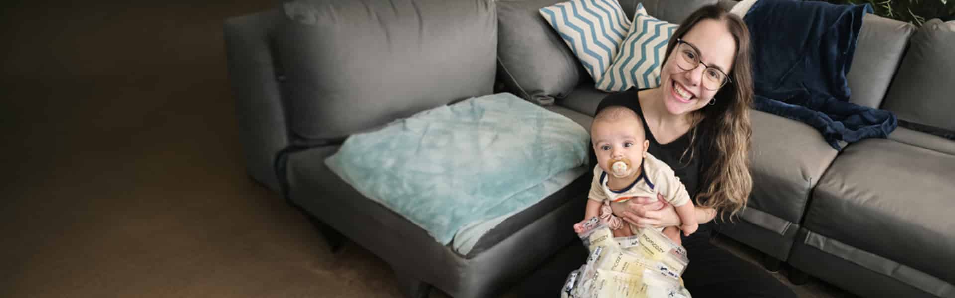 Milk Bank donor Tracy, with her baby, smiling at the camera